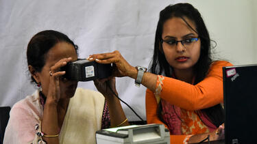 A woman having her eyes scanned at an Aadhaar registration office in Guwahati, India, in 2018. Photo: David Talukdar/NurPhoto via Getty Images.
