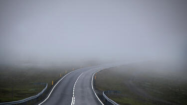 A road disappearing into fog