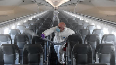 A contractor disinfecting a Frontier airplane at Denver International Airport in May 2020. Photo: AAron Ontiveroz/MediaNews Group/The Denver Post via Getty Images.