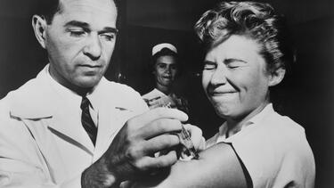 A nurse at Montefiore Hospital in New York City receives a flu vaccination in 1957. Photo: Everett Collection Historical/Alamy Stock Photo.