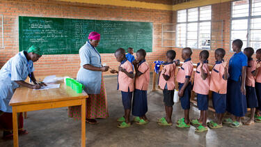 Students receiving a deworming treatment at a school in Rwanda. 