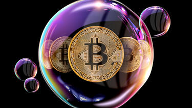Bitcoins floating in a bubble on a black background