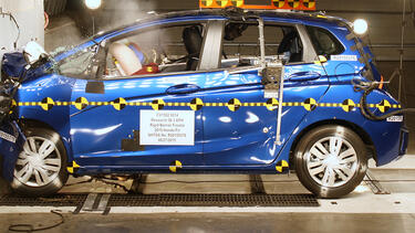 Honda Fit being crash tested into concrete inside a facility
