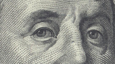 Detail of eyes from a $100 bill