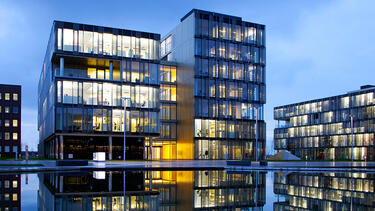 A photo of corporate headquarters campus reflected in water