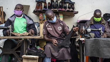 Cobblers wearing face masks at Kenyatta Market in Nairobi, Kenya, in April 2020. Photo: Patrick Meinhardt/Bloomberg via Getty Images.