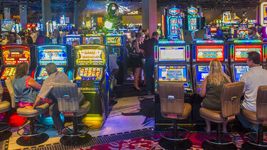 Casino floor showing several slot machines being played