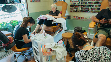Workers and customers in a nail salon