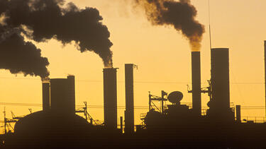 Factory smokestacks at sunset