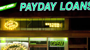Signs in the window of a payday lending business