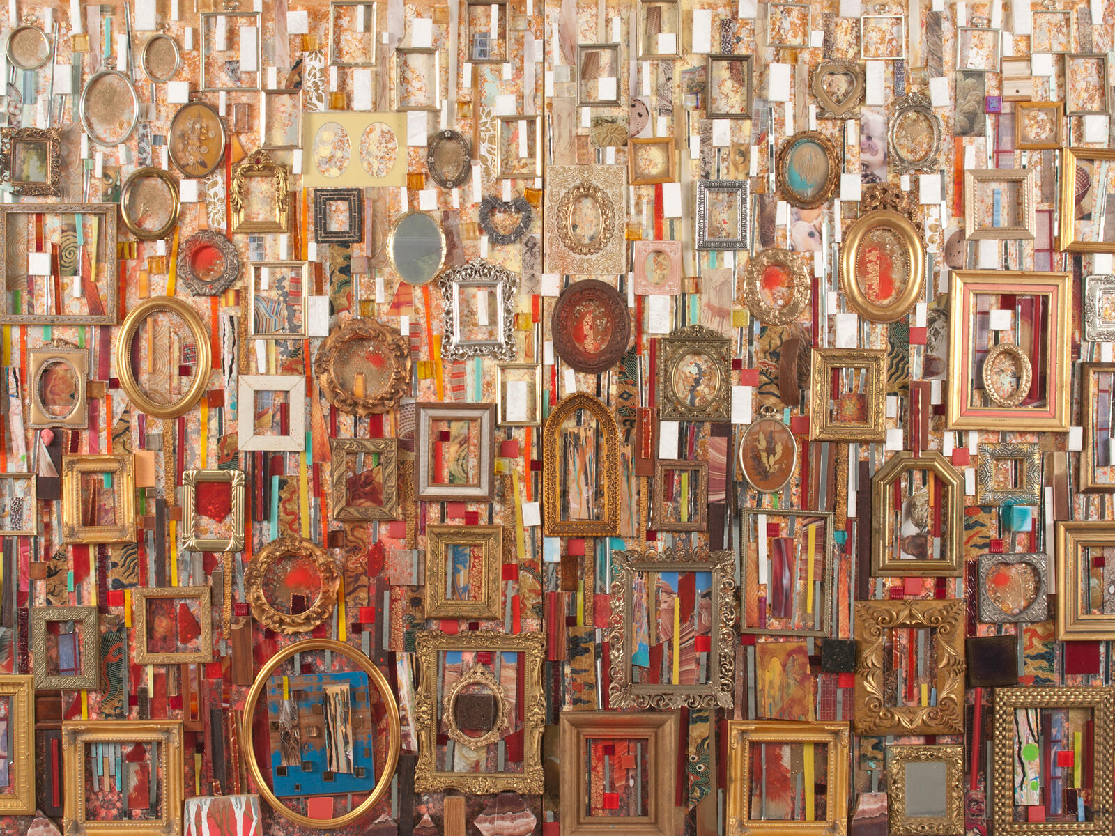 An abstract mixed media assemblage including picture frames of various colors and shapes