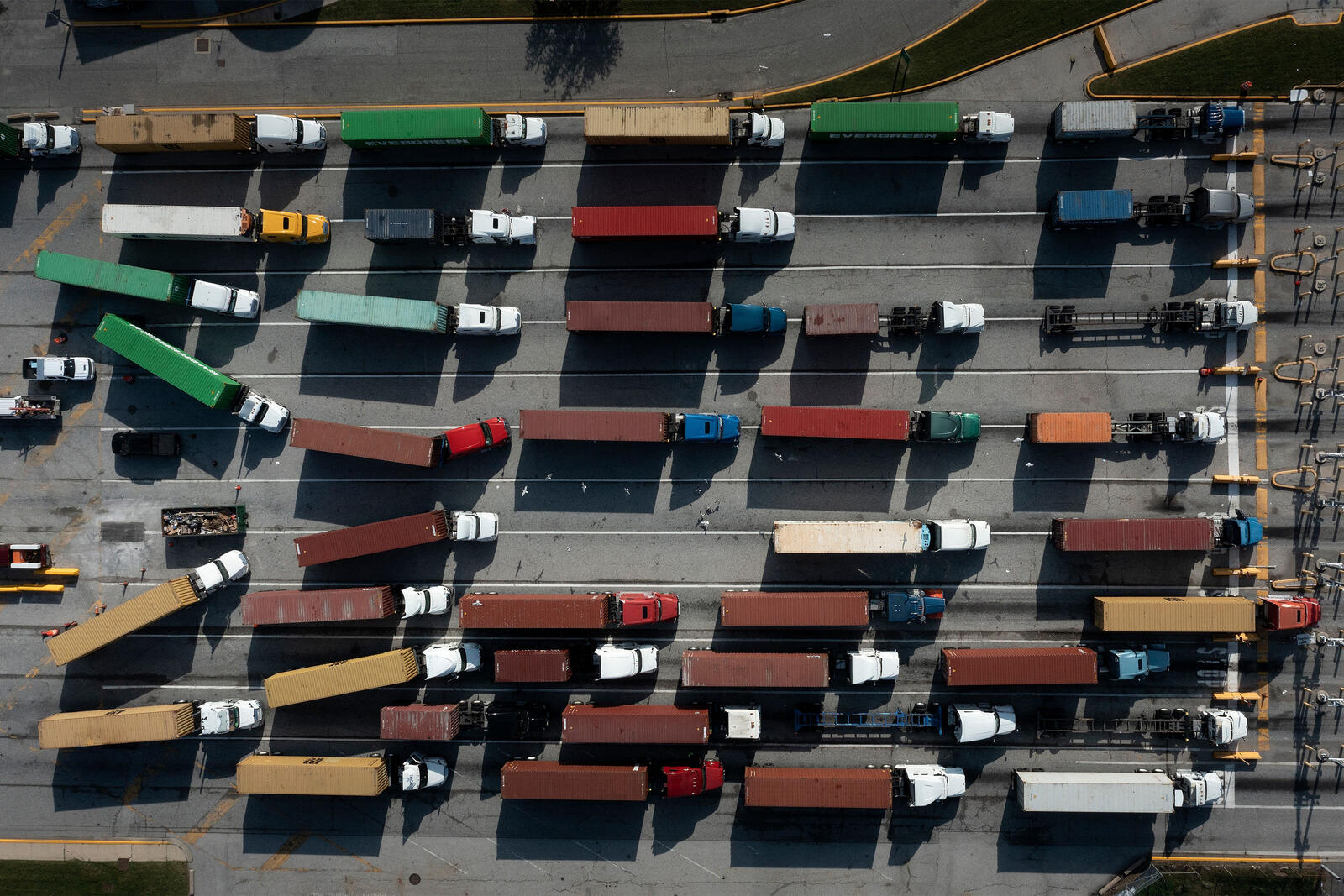 An overhead image of trucks carrying shipping containers