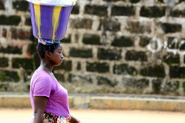 A woman walking just after the floods in Freetown, Sierra Leone