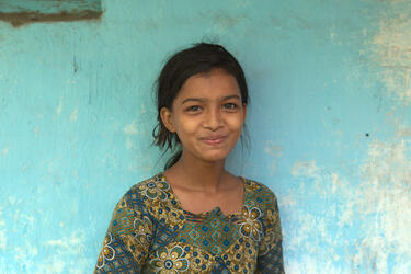 A girl outside of her house in Sunder Nagri, New Delhi, India