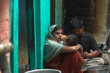 A family in Sunder Nagri, a settlement on the outskirts of New Delhi, India