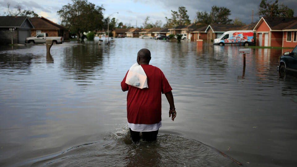 A resident walking through flooding from Hurricane Ida in LaPlace, Louisiana, on August 30, 2021