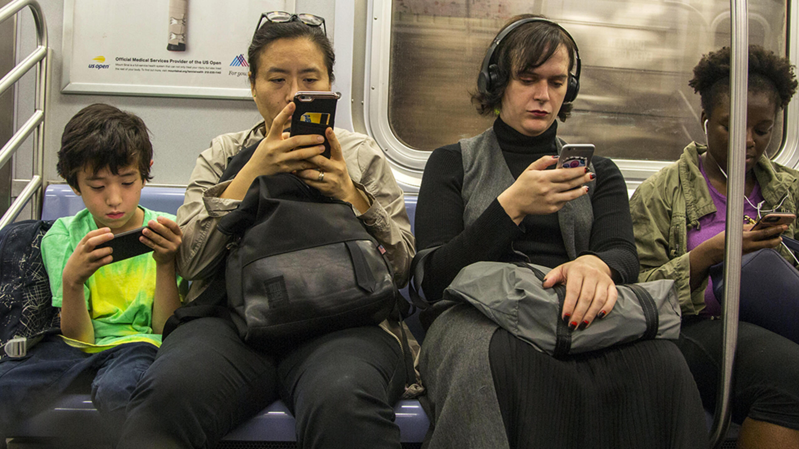 New York City subway riders using smartphones