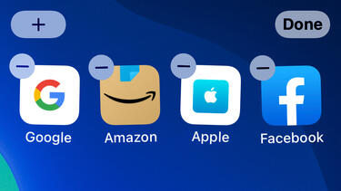 A group of apps for Google, Amazon, Apple, and Facebook in "jiggle mode," with delete buttons on each one