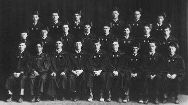 A group portrait of students from 1930 in academic robes 