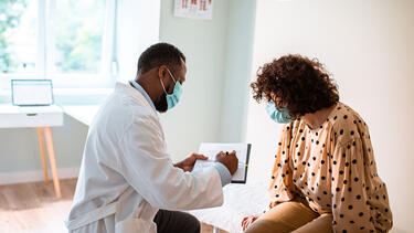 A doctor showing a chart to a patient
