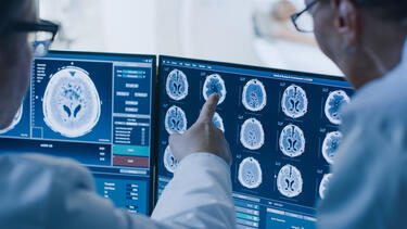 Doctors looking at scans on computer screens
