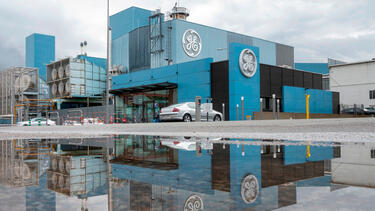 A General Electric facility in Belfort, France, reflecting in a body of water.