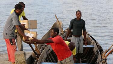 Men delivering supplies by boat