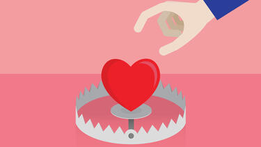 A hand reaching toward a heart in a bear trap