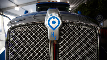 The hood of a semi truck with a hydrogen fuel cell logo