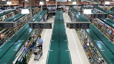 Shoppers in a supermarket seen from overhead