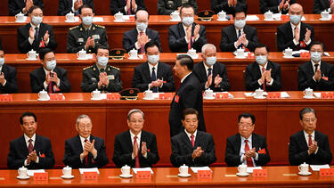 President Xi Jinping walking through a row of Chinese Communist Party officials.