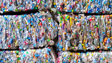 Bundles of crushed plastic containers