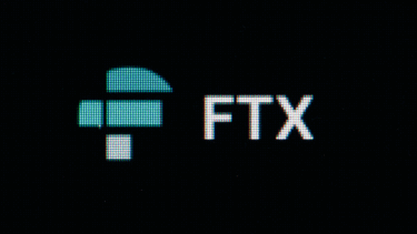An image of an FTX logo on a computer screen slowly fading to black