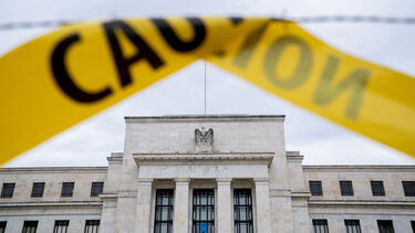 The Federal Reserve building seen past caution tape