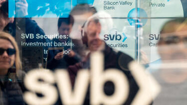 Customers at Silicon Valley Bank headquarters, seen through a window.