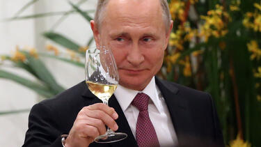 Vladimir Putin holding a wine glass