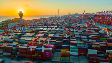 The sun setting over a vast field of shipping containers