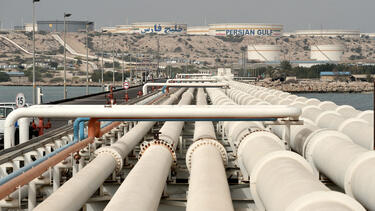 A series of oil pipelines, with oil tanks in the distance
