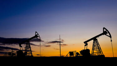 Oil pumps silhouetted against a sunset