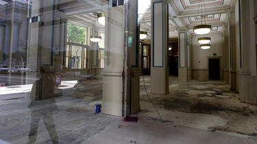 An empty ground-floor commercial space, seen through a window.