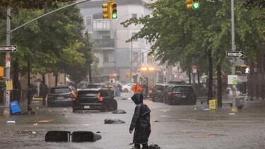 A person walking through a flooded street