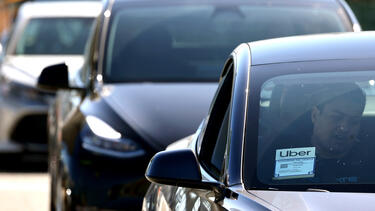 Uber cars lined up at an airport