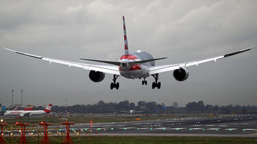 A plane over a runway