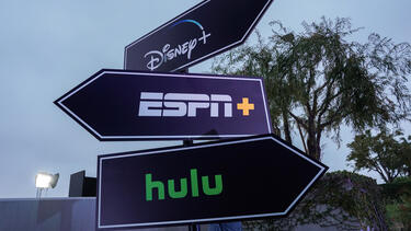 Directional signs with logos for Disney+, Hulu, and ESPN+.