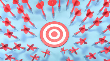 A target surrounded by darts