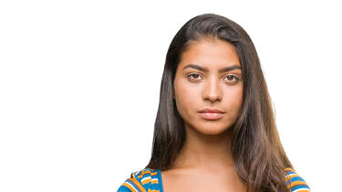 A young woman in front of a white background