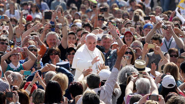 Pope Francis greeting a crowd in St. Peter’s Square