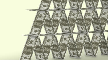 Card stacking pyramid with USD bills instead of cards