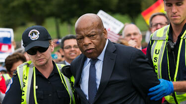 Congressman John Lewis is arrested for blocking traffic outside the U.S. Capitol at a protest in support of immigration reform in 2013. Photo: Drew Angerer/Getty Images.