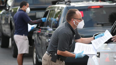 City employees handing out unemployment applications in Hialeah, Florida, in April 2020. Photo: Joe Raedle/Getty Images.